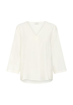 Blouse blanche à manches trois-quarts avec un décolleté en V. Fabriquée en tissu léger et texturé. Ourlet légèrement arrondi en bas.