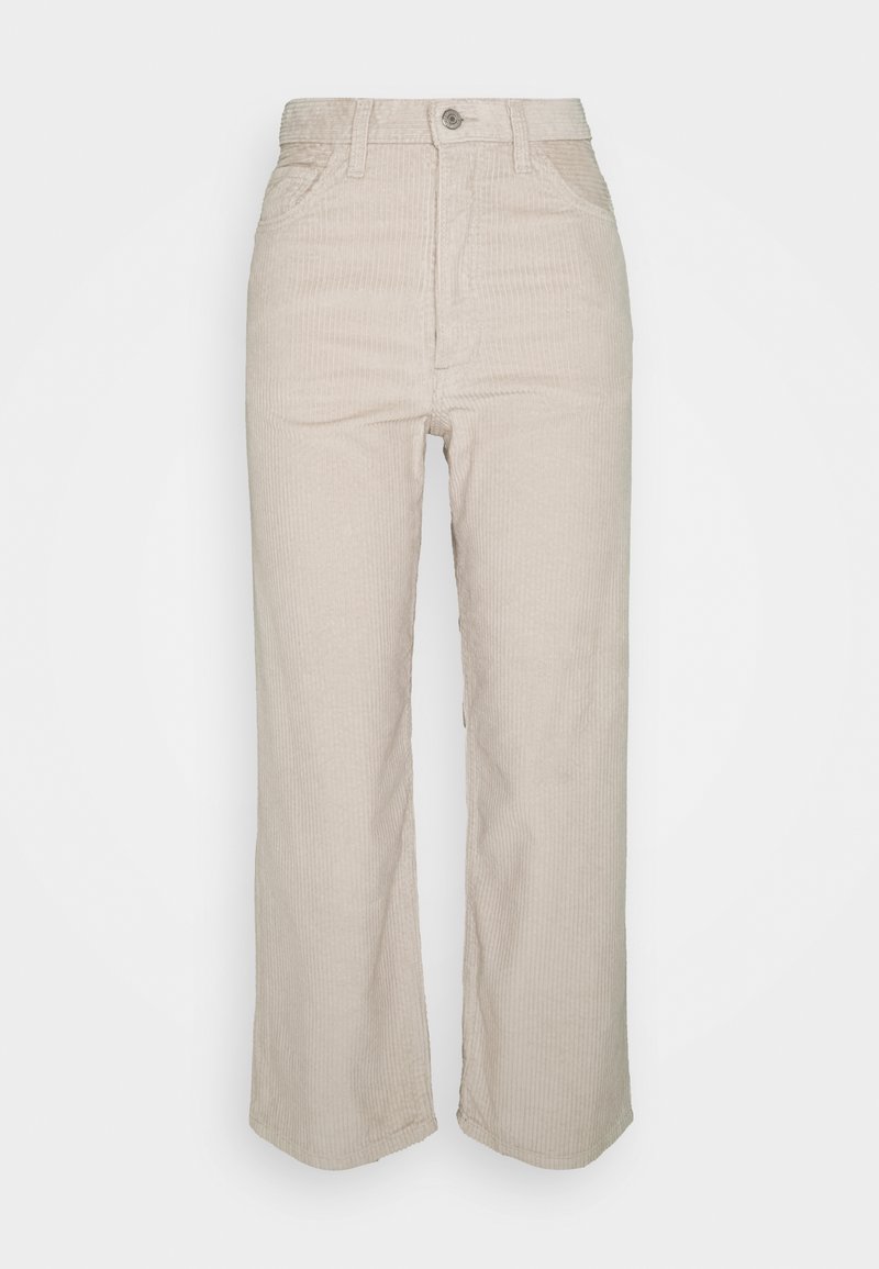Pantalon beige taille haute en velours côtelé avec passants pour ceinture, bouton à l'avant, fermeture éclair et coupe droite.