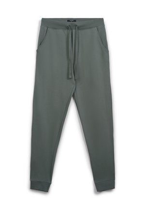 Pantaloni della tuta verde scuro realizzati in tessuto morbido, con fascia elastica in vita e coulisse, tasche laterali e polsini affusolati.
