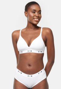 Set di reggiseno e pantaloni in cotone bianco con scollatura profonda, spalline sottili e ampia fascia elastica con logo "DIM" in nero.