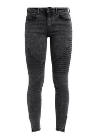 Jeans skinny de denim negro con paneles acanalados en las rodillas, corte ajustado y detalles de cremallera en el tobillo. Diseño clásico de cinco bolsillos.