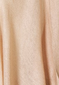 Light peach fabric with a soft, textured weave, featuring a subtle sheen. The material appears lightweight and slightly sheer.