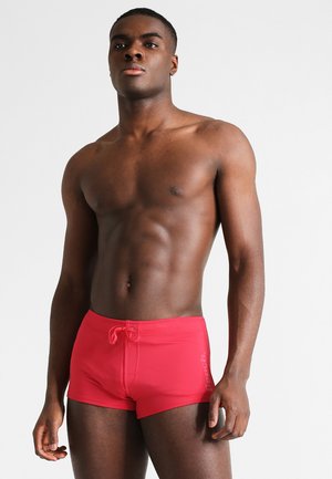 Rote Badehose aus elastischem Stoff, mit verstellbarem Bund und Logodetail an der Seite, in figurbetontem Design und glatter Textur.