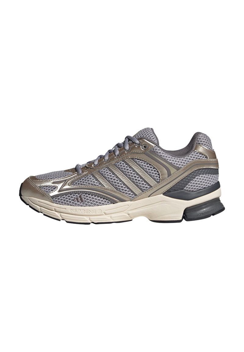 Grey running shoe with mesh upper, metallic accents, and a cushioned sole. Features ridged detailing on the sides and a sturdy rubber outsole.