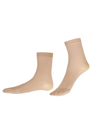 Beige knielange Socken aus transparentem Nylon mit glatter Textur, verstärkter Fußspitze und elastischen Bündchen, die ein klassisches Design aufweisen.