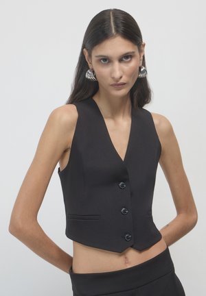 Black cropped vest with a deep V-neck, single-breasted button closure, and two front pockets. Sleek fabric with smooth texture.