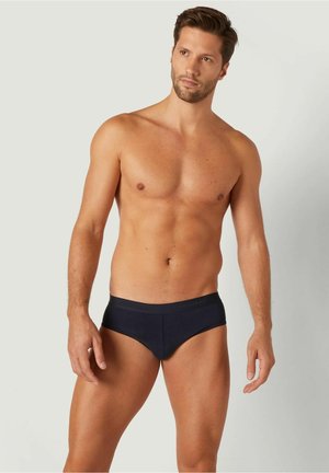 Marineblaue Herren-B briefs mit einem weichen, elastischen Bund und einer glatten Textur. Figurbetontes Design mit einem minimalistischen Schnitt.