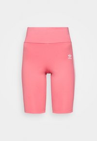 Růžové legíny z hladké látky, s pasem ve střední výšce a přiléhavým střihem. Na levé straně je bílý logo Adidas.