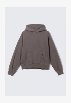 Sweat à capuche oversize marron avec une poche frontale, un ourlet et des poignets côtelés ; fabriqué en tissu doux et texturé, il est doté d'une capuche avec cordon de serrage.