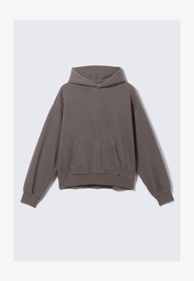 Sweat à capuche oversize marron avec une poche frontale, un ourlet et des poignets côtelés ; fabriqué en tissu doux et texturé, il est doté d'une capuche avec cordon de serrage.