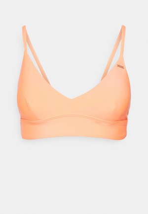 Bralette laranja claro com decote em V profundo, alças finas ajustáveis, textura suave e faixa inferior estreita. Design minimalista sem fechos.