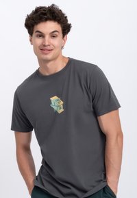 Grijze t-shirt met korte mouwen met een klein, kleurrijk ontwerp van een houten structuur op de borst. Soepele stof; casual fit.