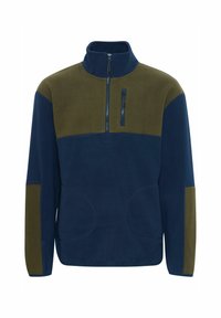 Pull-over en polaire bleu marine et olive, avec un col zippé mi-hauteur, des poches frontales et un design à panneaux contrastants. Texture douce. Coupe décontractée.