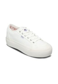 White low-top sneaker with thick sole, lace-up front, textured material, and "Roxy" small side label on a white background.