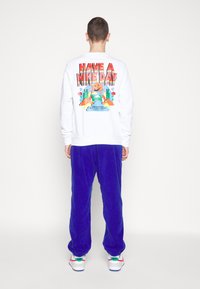 Nike Sportswear AIR WINTER PANT - Cargo trousers - deep royal blue/white