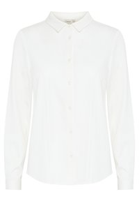 Blusa bianca a maniche lunghe con collo a camicia, chiusura frontale con bottoni e tessuto leggero e morbido. Orlo leggermente curvo e vestibilità sartoriale.