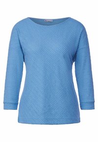 Ljusblå strukturerad tröja med lös passform. Har en bred rund halsringning, trekvartslånga ärmar och ett diagonalt m önster. Mjuk tyg.