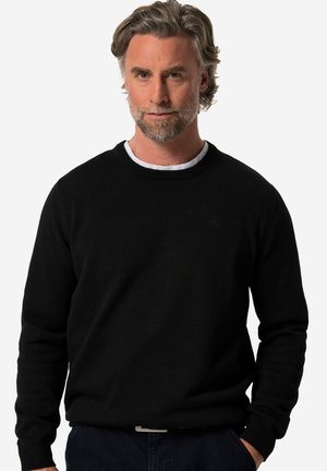 Black knit sweater with a round neckline and long sleeves. Smooth texture, ribbed cuffs and hem, featuring a subtle logo on the front.