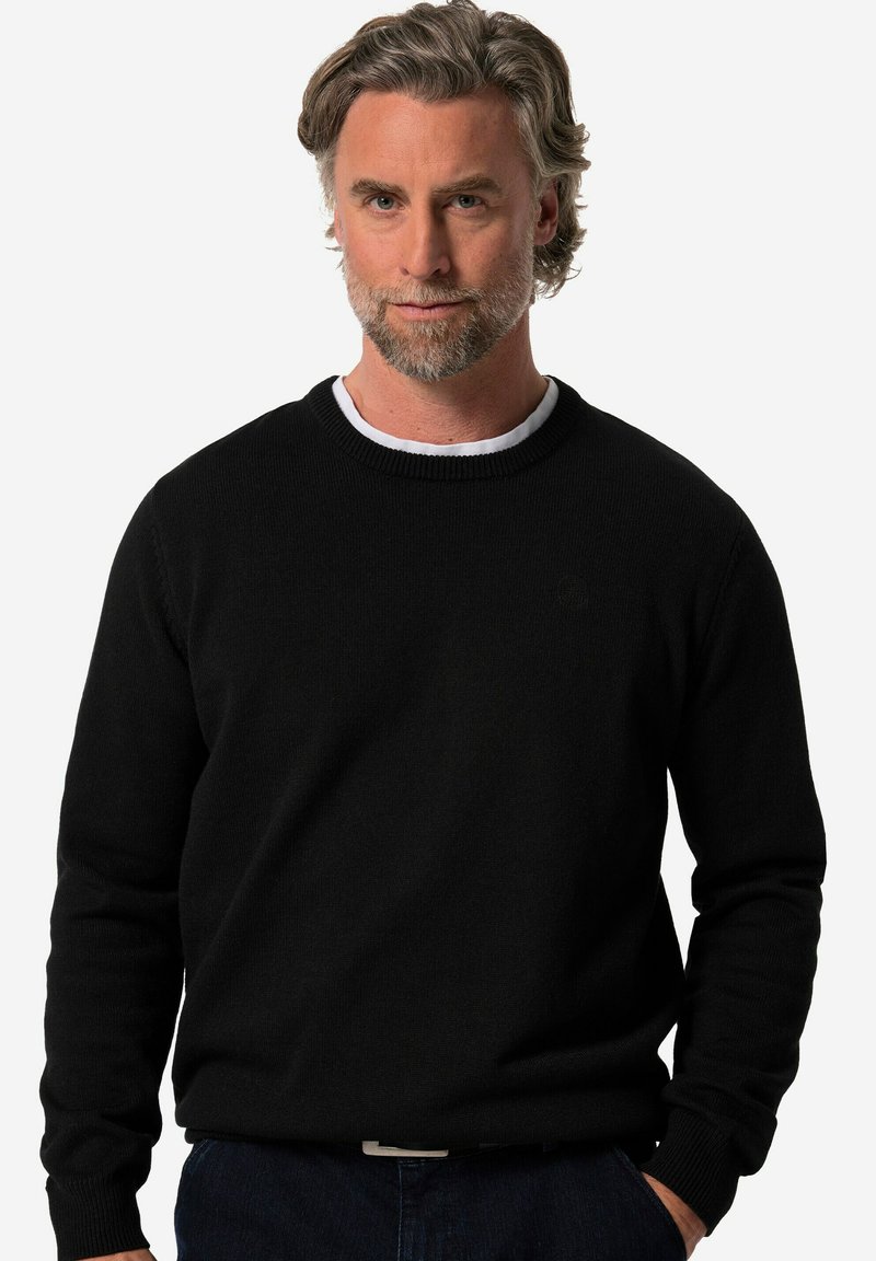 Mustapaita, jossa on pyöreä kaula-aukko ja pitkät hihat. Tasainen pinta, ribbaatut hihansuut ja helma, etupuolella on huomaamaton logo.