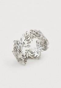 Silver ring with intricate cut-out floral and leaf patterns, forming a continuous, open circular design.