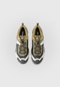 Trail shoes with a black and olive upper, textured mesh, white accents, and a reinforced toe. Features elastic laces and a pull tab.