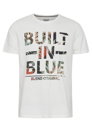 White cotton T-shirt featuring bold text "BUILT IN BLUE" with a floral pattern overlay. Short sleeves, crew neck, and relaxed fit.