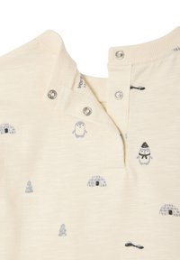 Light beige short-sleeve shirt with penguin and igloo patterns. Features snap closure and textured fabric. Metallic snaps at the collar.