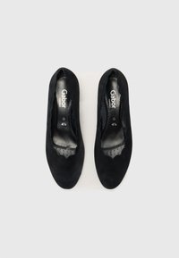 Black suede ballet flats with a scalloped edge and perforated insole, featuring "Gabor" branding. Classic slip-on design suitable for various occasions.