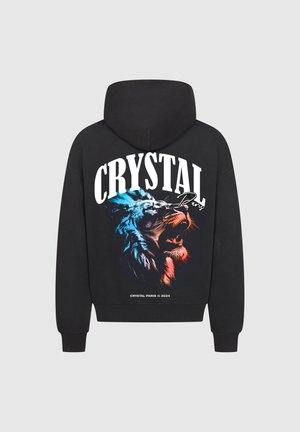 Zwarte hoodie met een grote grafische afbeelding van een leeuwengezicht in blauw en oranje, met de tekst "CRYSTAL Paris" en een kangoeroezak.