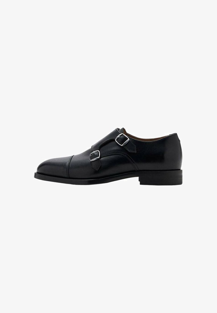 Black leather dress shoe with dual buckles, a rounded toe, and a smooth finish. Features a low heel and sleek silhouette.