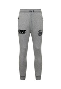 Grijze joggingbroek gemaakt van een katoenmix. Voorzien van zijzakken, een taillekoord en zwarte bedrukt logo's op de linkerdij en rechterpijp.