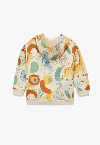 Beige lasten huppari, jossa on värikkäitä eläinkuvioita, kuten leijonia, seepruja, giraffeja ja tiikereitä. Hupparissa on huppu sekä ribbireunat hihansuissa ja helmassa.