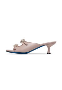Open-toe heeled mules in soft beige leather. Features two decorative crystal bows, a blue accent on the sole, and a unique horn-shaped heel.
