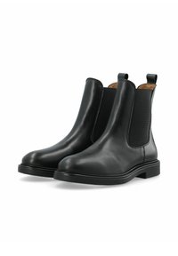 Stivali Chelsea in pelle nera con pannelli elastici sui lati, punta tonda e suole in gomma piatta. Presentano un profilo Slim e linguette per una facile calzata.