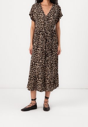 Maxi-jurk met panterprint, V-hals, korte mouwen, een geaccentueerde taille en een gelaagde rok. Gecombineerd met zwarte flats met gestrikte enkeldetails.