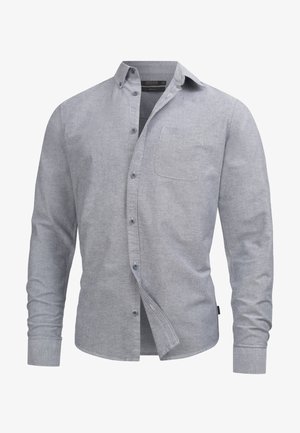 Camicia grigia con bottoni realizzata in tessuto testurizzato, dotata di tasca sul petto, colletto classico e polsini con bottone.