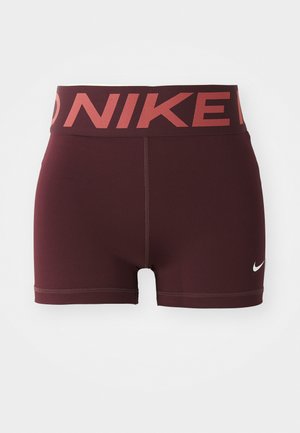 Burgundy athletic shorts with a wide waistband featuring the "NIKE" logo in a contrasting red. Made from smooth, stretchy material.