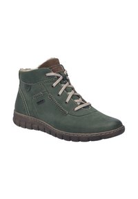 Bottines en cuir vert avec des lacets et une doublure beige, surface texturée, bout arrondi et semelle en caoutchouc avec un motif de crampons visible.