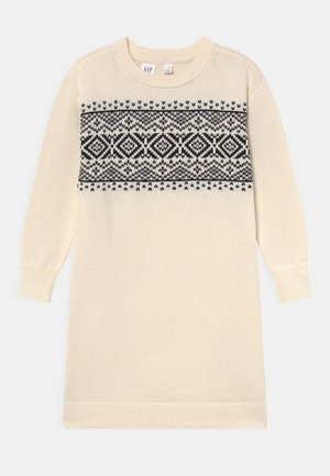 Robe en maille crème à manches longues avec motif géométrique et losange noir sur la poitrine, poignets et ourlet côtelés.