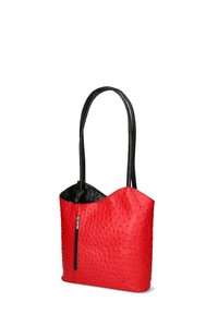 Rode leren handtas met een gewelfde zwarte ontwerp, voorzien van een ritsvak aan de voorkant en twee lange zwarte hengsels.