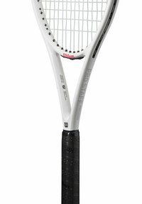 White tennis racket with a black textured grip, featuring a wide oval head and pronounced frame, marked with "Wilson Pro Staff Precision."