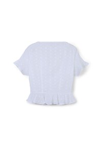 Tunique peplum blanche en tissu ajouré, dotée de manches courtes à volants, de découpes florales et d'un ourlet froncé. L'arrière présente un design sans couture.