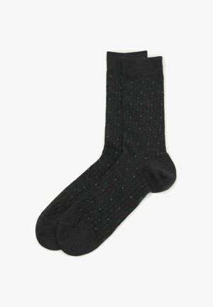 Mørkegrå sokker med ribbet tekstur, prydet med et mønster af små blå og grønne prikker.