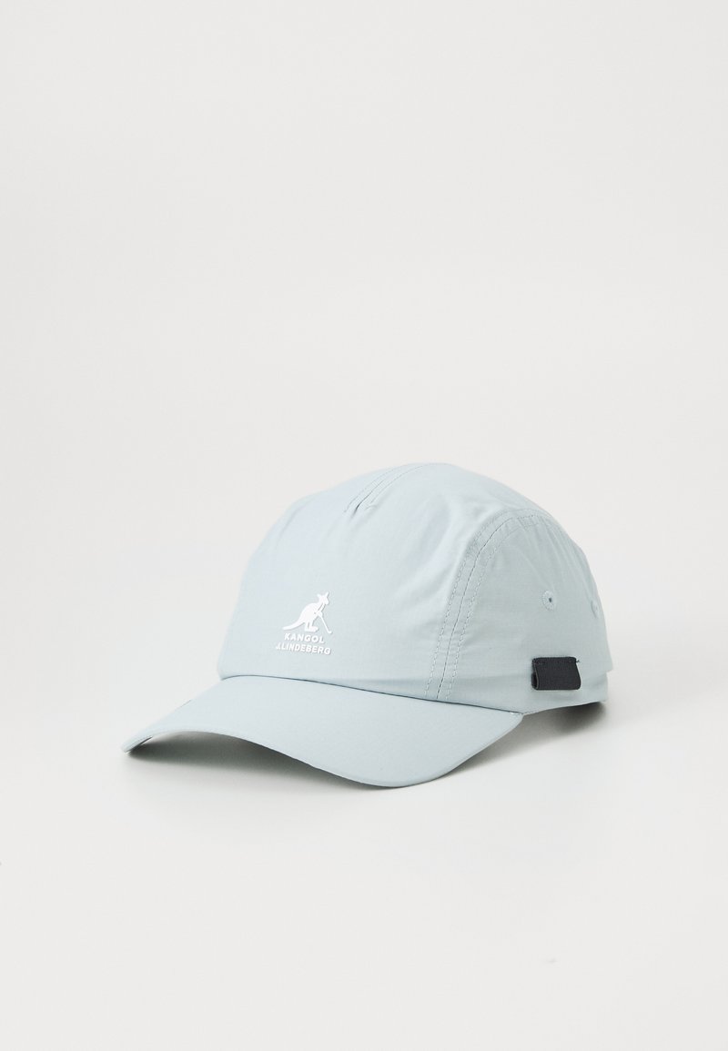 Light blue cap made of nylon with a curved brim, featuring a white logo and an adjustable black strap on the back. Smooth texture.