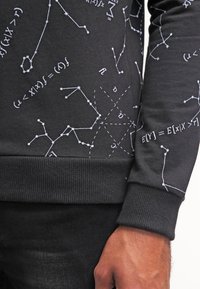 Black sweatshirt featuring white mathematical symbols and diagrams across the fabric. Ribbed cuffs and hem. Soft texture.