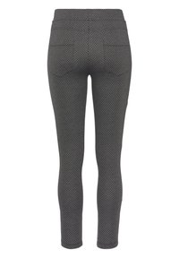 Zwarte leggings met een diamantpatroon, elastische tailleband en twee achterzakken. Gemaakt van een rekbare, gestructureerde stof.