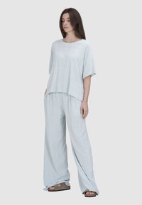 Lichtblauw loungewear-set van zachte stof, met een losse short-sleeve top en brede broekspijpen, met een ontspannen silhouet.