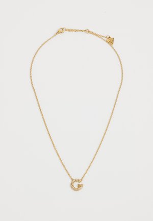 Gouden ketting met een delicate schakel, met een sprankelende letter "G" hanger versierd met strass.