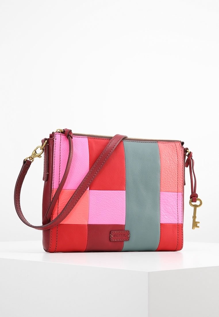 Sac en cuir rectangulaire avec un design en patchwork multicolore dans les tons rouge, rose et vert. Il possède une bandoulière et un accent en forme de clé.