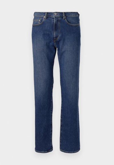Jean en denim bleu avec une coupe droite, cinq poches, une fermeture éclair et un bouton en métal. Légère décoloration sur le tissu.